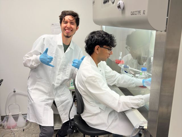 Andrew teaching Kaahil how to do cell culture